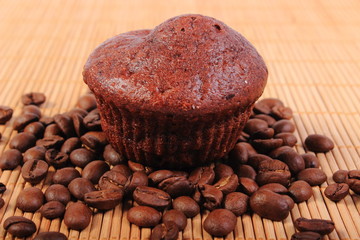 Fresh baked chocolate muffins and coffee grains