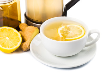 Hot honey lemon and ginger drinks in cup and filter jar