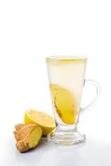 Hot ginger and lemon tea in transparent tall glass