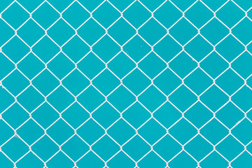 White wire fence on green background