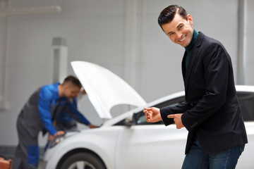 Portrait of Happy Customer in Auto Repair Shop 