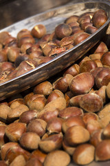 Roasted chestnuts on market stall.