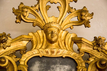 detail of a carved frame of an antique mirror