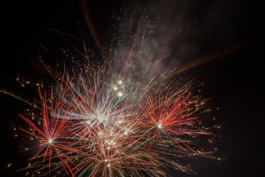 Sparks celebratory salute against a black backdrop of the sky.