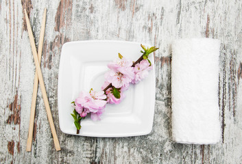 plate, chopsticks and sakura branch