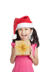 Happy little asian girl with santa hat and gift box