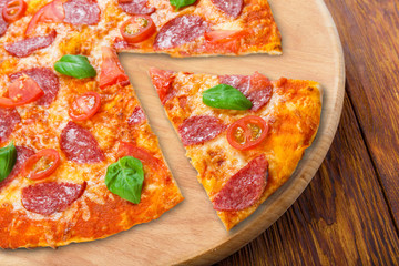 Delicious pizza with salami and cherry tomatoes