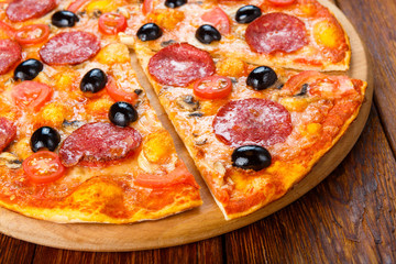 Delicious pizza with salami, mushrooms and olives