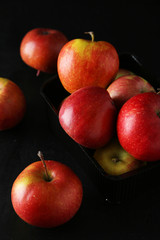 Apples in basket on black background