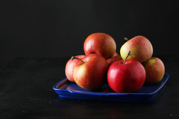 Fototapeta na wymiar Apples on tray on black background