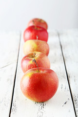 Apples on white wooden background