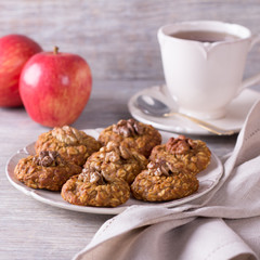 Oatmeal cookies with walnuts, apples and a cup of tea
