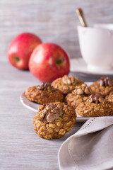 Oatmeal cookies with walnuts, apples and a cup of tea 