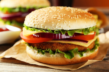 Fresh burger on brown wooden background