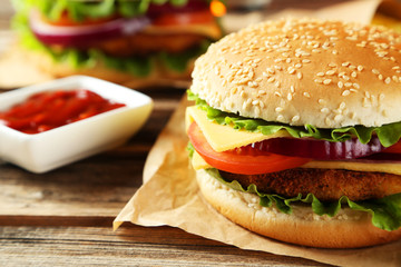 Fresh burgers on brown wooden background
