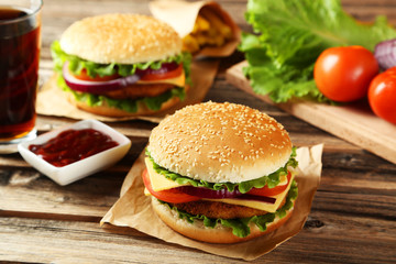 Fresh burgers on brown wooden background