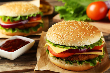Fresh burgers on brown wooden background