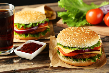 Fresh burgers on brown wooden background