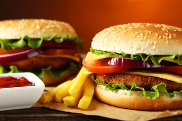 Fresh burgers on brown wooden background