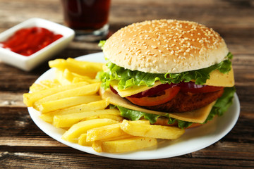 Fresh burger on plate on brown wooden background