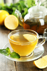 Cup with green tea on wooden background