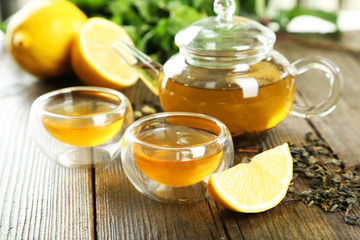 Cup with green tea on wooden background