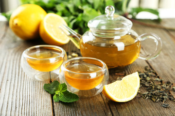 Cup with green tea on wooden background
