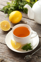 Cup with green tea on wooden background