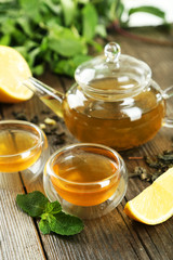 Cup with green tea on wooden background