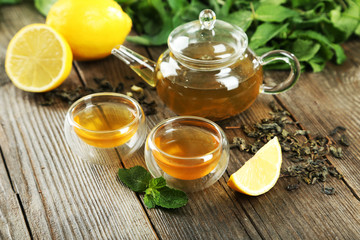 Cup with green tea on wooden background