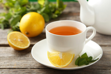 Cup with green tea on wooden background