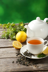 Green tea in cup and teapot 