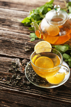 Cup with green tea and teapot 