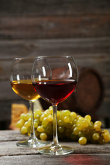 Glass of red and white wine, cheeses and grapes 
