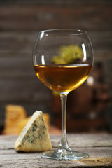 Glass of red and white wine, cheeses and grapes 