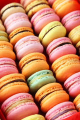 French colorful macarons on pink background