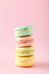 French colorful macarons on pink background