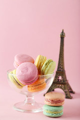 French colorful macarons on pink background