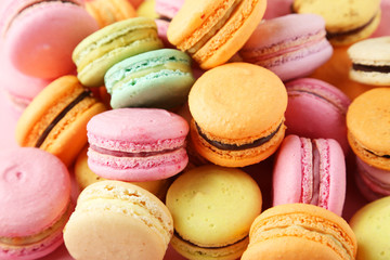 French colorful macarons on pink background