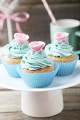 Tasty cupcake on grey wooden background