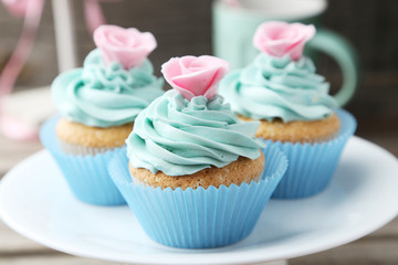Tasty cupcake on grey wooden background