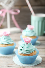 Tasty cupcake on grey wooden background