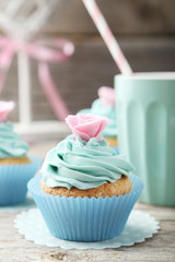 Tasty cupcake on grey wooden background