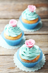 Tasty cupcake on grey wooden background