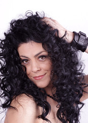 Fototapeta premium Beautiful brunette woman with beauty long curly hair