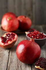 Delicious pomegranate fruit on grey wooden background