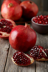 Delicious pomegranate fruit on grey wooden background