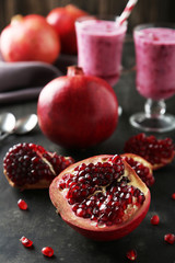 Delicious pomegranate fruit on black background