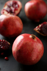 Delicious pomegranate fruit on black background
