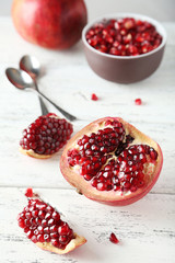Delicious pomegranate fruit on white wooden background